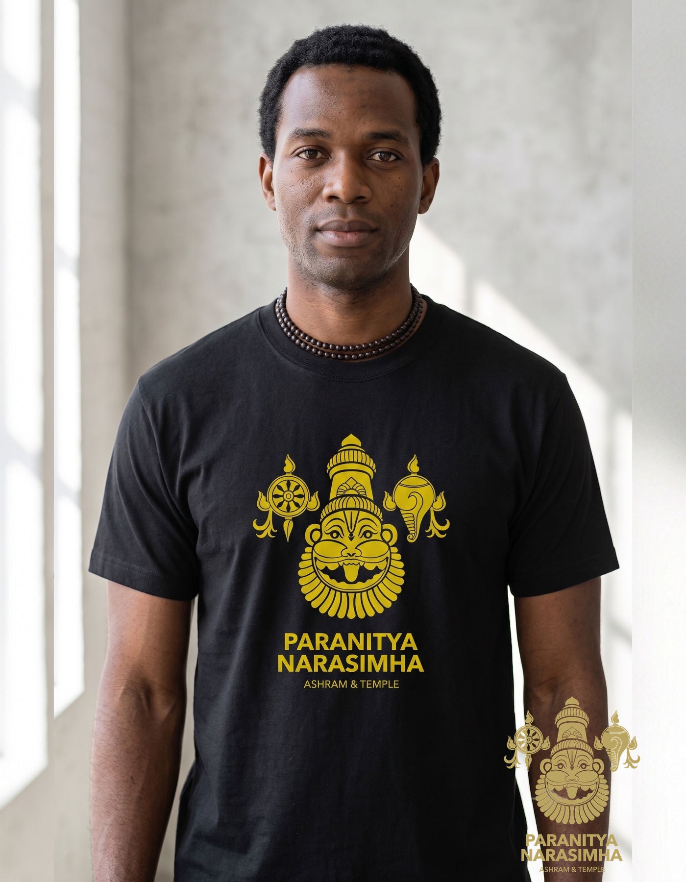 Close-up of gold Narasimha face, shank, and chakra print on black cotton tee - Bhakti Shop
