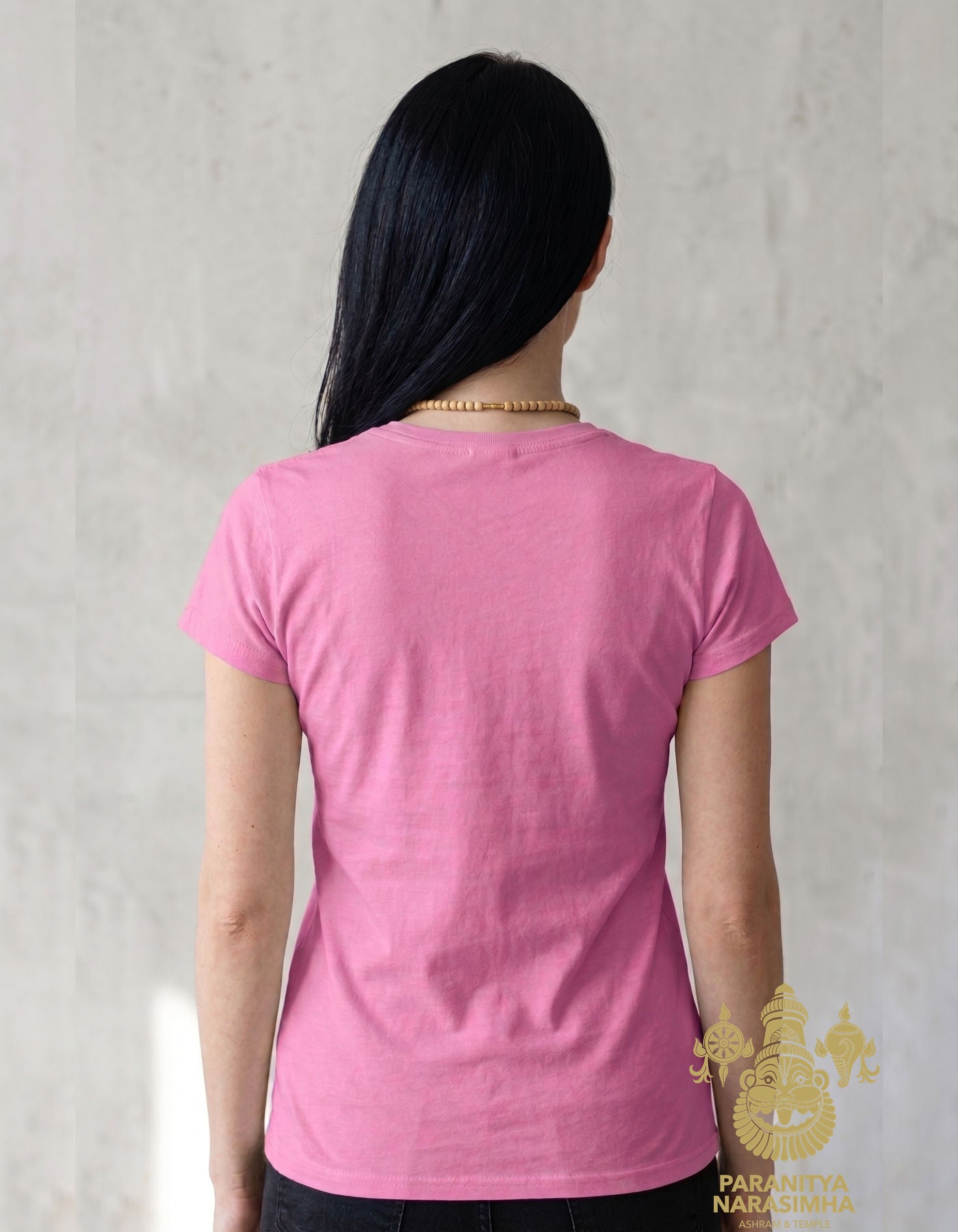 Woman wearing light pink Paranitya Narasimha t-shirt with cap sleeves - Bhakti Shop
